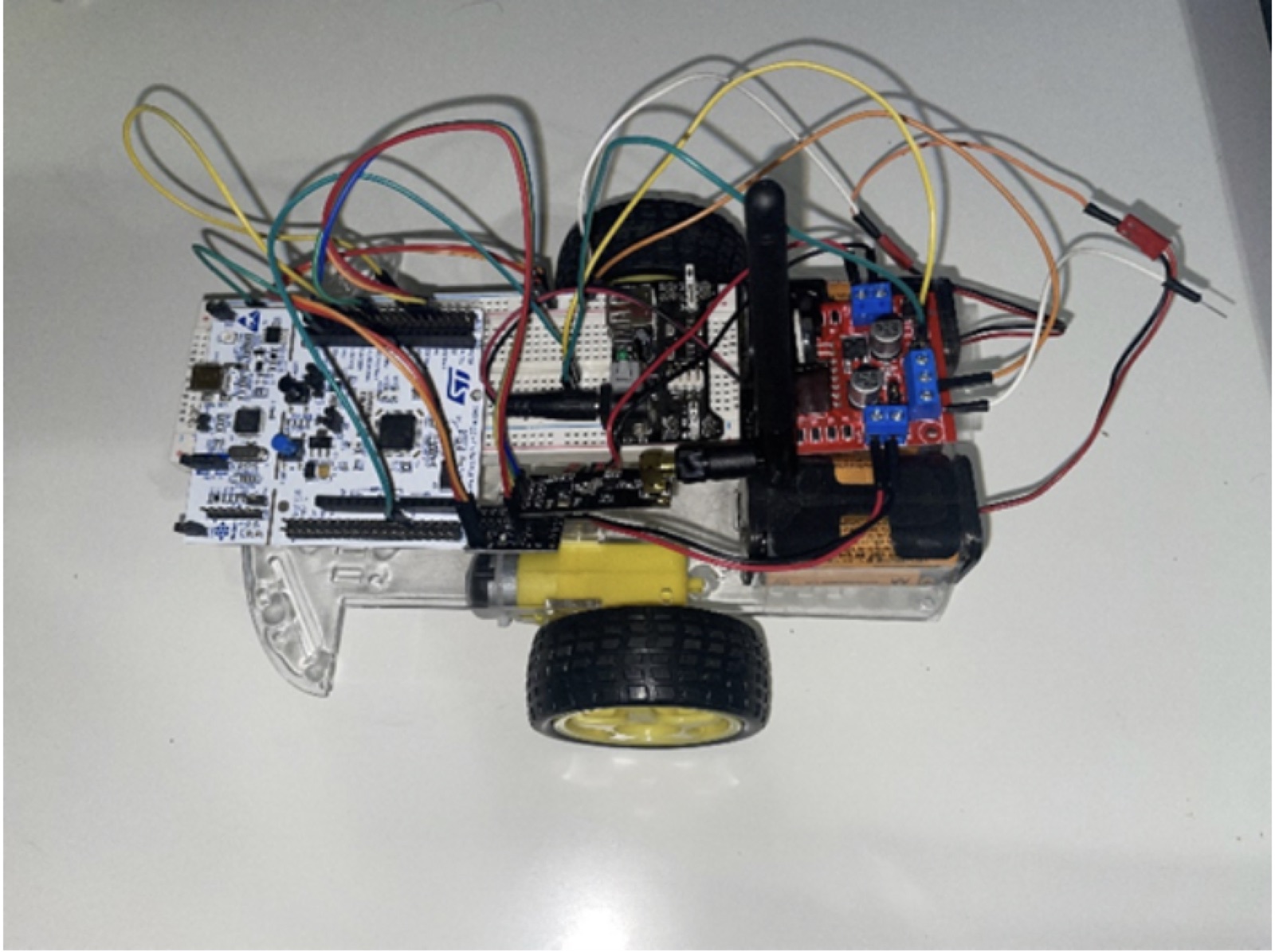 The RC car with its STM32 board, radio, and motor driver